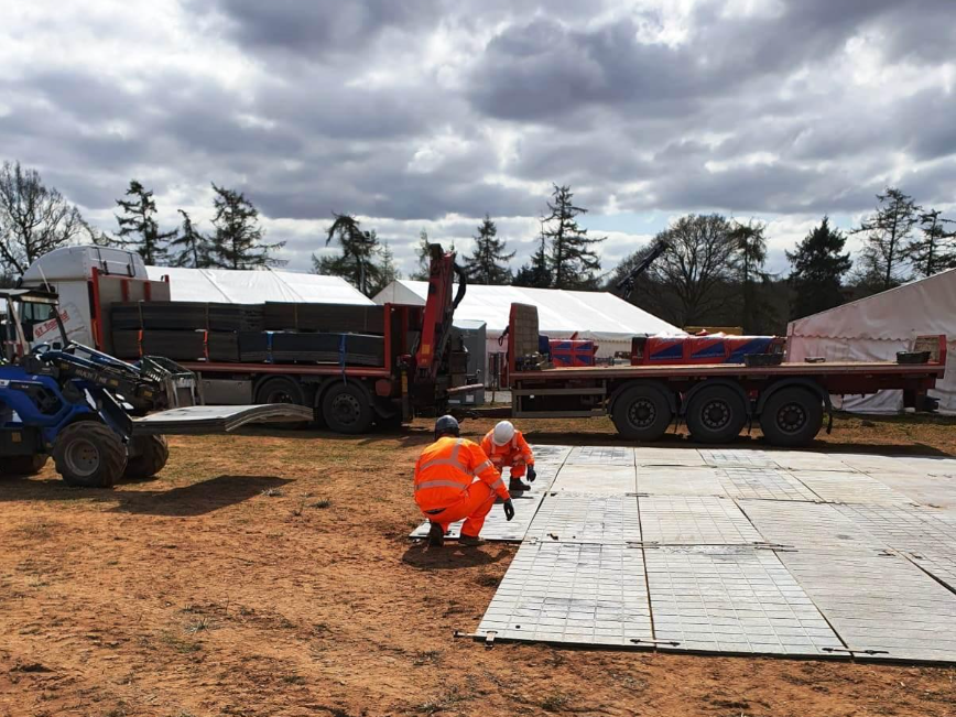 Workers laying mats